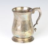 A George II silver baluster mug with fancy S scroll handle, engraved a double armorial, London 1737,