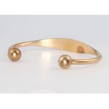 A 9ct yellow gold torque bangle, 21.2 grams