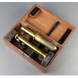 A student's 19th Century unmarked brass and metal single pillar microscope boxed