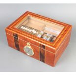 An inlaid cedar humidor with hinged lid containing a collection of various cigars, 15cm x 35cm x