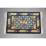 A blue and peach ground Chinese rug 95cm x 60cm This rug is in good condition having only minimal