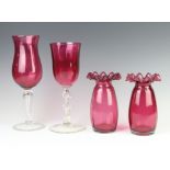A pair of Victorian style cranberry glass vases with wavy rims 17cm, a similar glass and vase