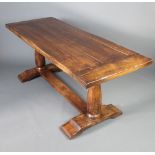 An elm refectory style dining table, the top formed of 5 planks, raised on turned supports with H