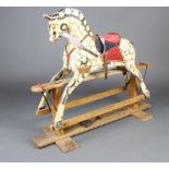 A dapple grey rocking horse on a beech stand 109cm h x 134cm w x 34cm d The bottom jaw of the