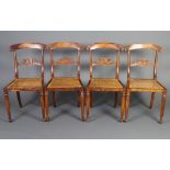 A set of 4 William IV mahogany bar back dining chairs, the mid rail carved an armorial figure with