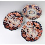 A pair of shell shaped Imari scalloped dishes decorated with exotic birds 23cm, a ditto plate