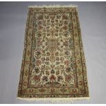 A white ground and floral patterned Persian carpet with central medallion within a multi row border,