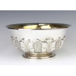 A Sterling silver repousse punch bowl decorated with acanthus leaves and with gilt interior, 24.5