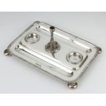 A Victorian rounded rectangular silver 3 division ink stand with pen trays, raised on ball feet with