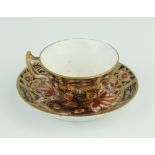 A Royal Crown Derby Imari pattern miniature tea cup and saucer