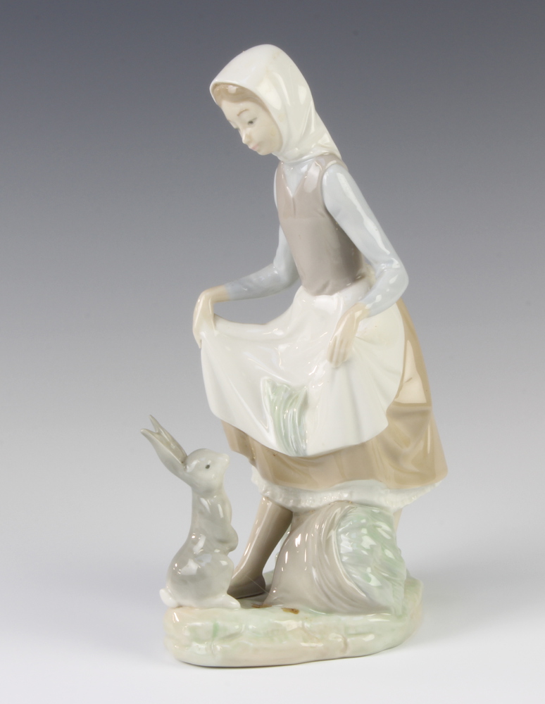 A Lladro figure of a young lady with a rabbit at her feet no.4326, 22cm