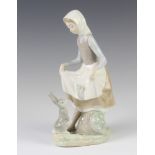 A Lladro figure of a young lady with a rabbit at her feet no.4326, 22cm