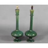 A pair of stylish green glazed Studio Pottery vases with elongated necks converted to electricity