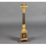 A gilt ormolu Empire style reeded column table lamp raised on a triform base with paw feet 72cm h