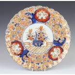 A Imari scalloped dish with panels of flowers 30cm