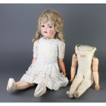 A 19th Century German porcelain headed doll with open and shutting eyes, open mouth, the head