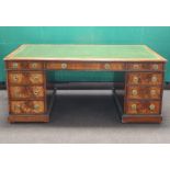 A Victorian mahogany partners desk with inset tooled green leather writing surface, above 2 long and