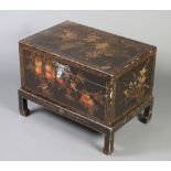 A rectangular Oriental black lacquered and floral patterned twin handled coffer on detachable