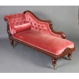 A Victorian carved mahogany show frame chaise longue upholstered in rose pink buttoned Dralon,