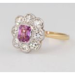 An 18ct yellow gold pink sapphire and diamond cluster ring, the centre stone approx. 1.1ct