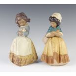 Two Lladro matt figures of girls, 1 holding a rabbit 2094, 21cm, another carrying a basket 21cm