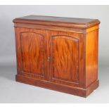 A Victorian mahogany side cabinet with fluted decoration, fitted a shelf enclosed by arched panelled