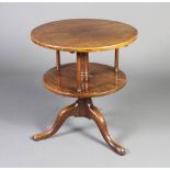 An 18th Century style circular oak 2 tier revolving occasional table raised on a pillar and tripod