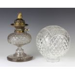 An Edwardian cut glass oil lamp with spherical shade and circular base 46cm