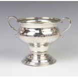 A silver two handled baluster cup decorated with flowers 11cm, London 1922, 200 grams