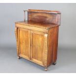 A Regency bleached mahogany chiffonier with raised back, the base enclosed by panelled doors, raised