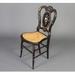 A Victorian papier mache and inlaid mother of pearl bedroom chair with woven cane seat raised on