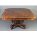 A William IV rectangular shaped mahogany library table raised on a turned column, triform base