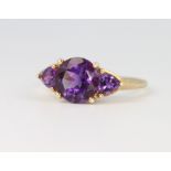 A 9ct yellow gold 3 stone amethyst ring size O, 2.4 grams