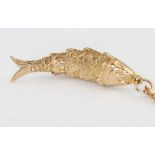 A 9ct yellow gold articulated fish pendant and chain 9.2 grams