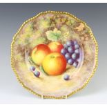 A Royal Worcester plate decorated with fruits, decorated by H Aynton 27cm
