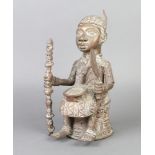 A Benin bronze of a seated figure 26cm x 14cm x 15cm