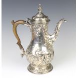 A good George III baluster repousse coffee pot, later decorated with scrolling flowers, with 2