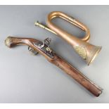 A reproduction flintlock pistol with 29cm barrel together with a reproduction copper and brass bugle