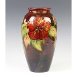 A modern Moorcroft oviform vase, the red ground decorated Hibiscus 30cm