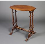 A Victorian shaped walnut occasional table raised on 4 turned supports with H framed stretcher