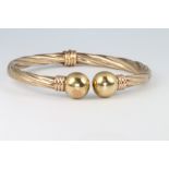 A 9ct yellow gold sprung torque bracelet, gross 10.5 grams