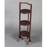 A 1930's circular mahogany 3 tier folding cake stand 93cm h x 23cm diam.