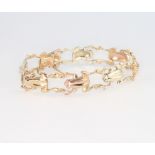 A 9ct 2 colour gold frog bracelet, set with ruby eyes, 22.8 grams
