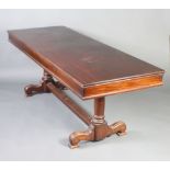 A late 19th Century rectangular mahogany library table, raised on 2 turned columns with H framed