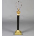 A polished stone and gilt metal table lamp with Corinthian capital column, raised on square