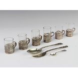 A set of 3 silver tots with matched glass liners, and 3 other silver tot holders with glass liners