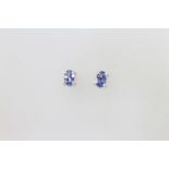 A pair of silver and tanzanite ear studs