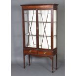 An Edwardian mahogany display cabinet, the upper section with moulded cornice, fitted shelves