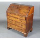 A Georgian mahogany bureau, the fall front revealing a well fitted interior above 4 long drawers