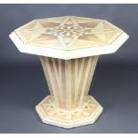 Mid 20th Century, an octagonal faux marble centre table, raised on a chamfered octagonal column